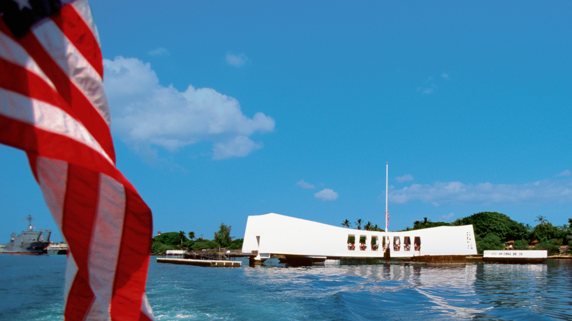US Flag flying off the back of the USS Arizona in Pearl Harbor, Oahu, Hawaii, USA