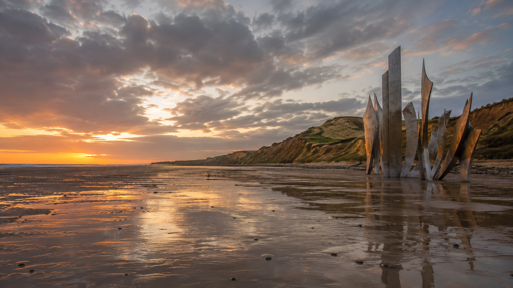 Omaha Beach at low tide in Normandy with the bluffs behind, site of the D-Day landings
