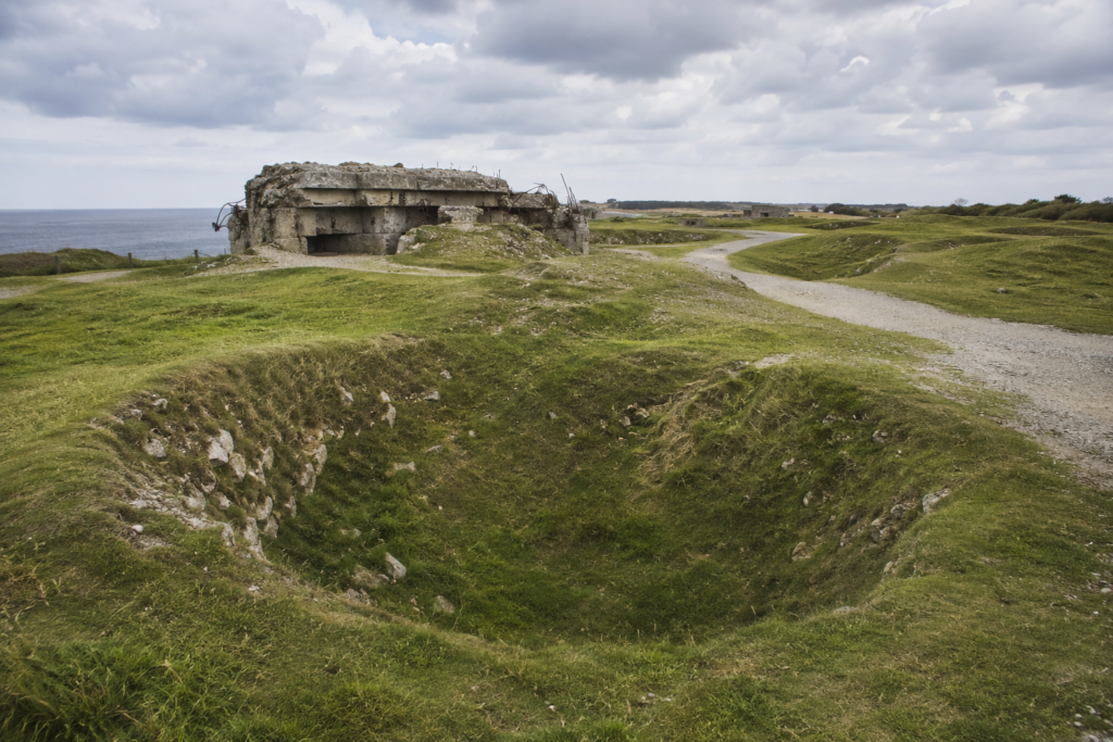 Bomb craters and ruined German bunkers preserved at the Pointe du Hoc battlefield site