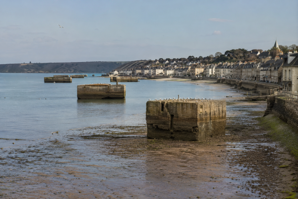 Remains of the Mulberry artificial harbour visible at low tide in the bay at Arromanches, Gold Beach.