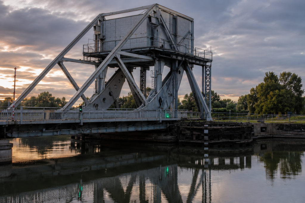 Steel lifting bridge over the Caen Canal at dusk, site of the Pegasus Bridge operation near Sword Beach.