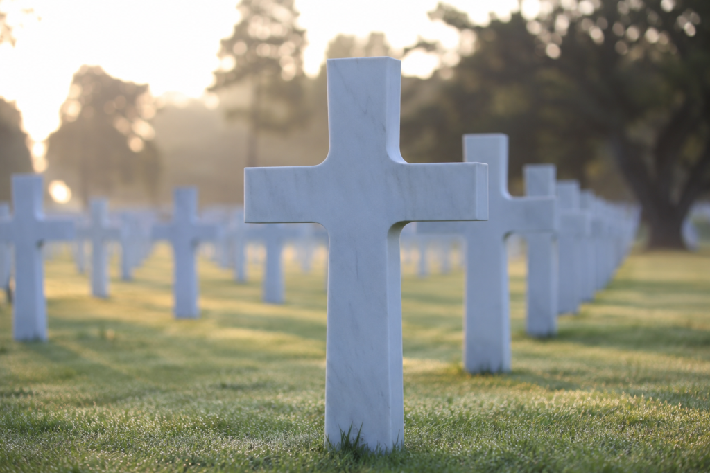 Close-up of a white marble cross headstone among rows of graves at Colleville-sur-Mer