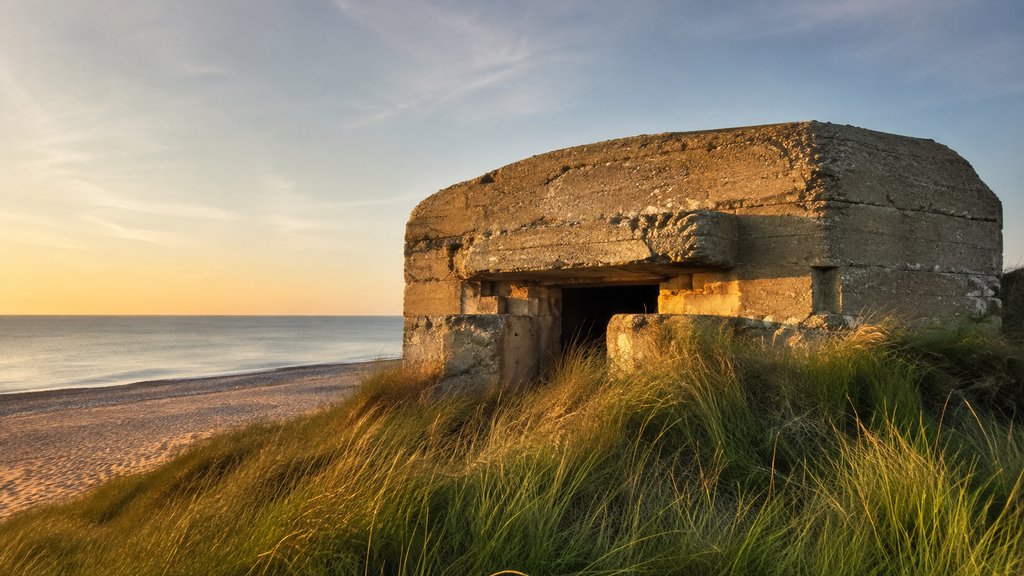 WWII bunker on a Normandy beach in golden light, France